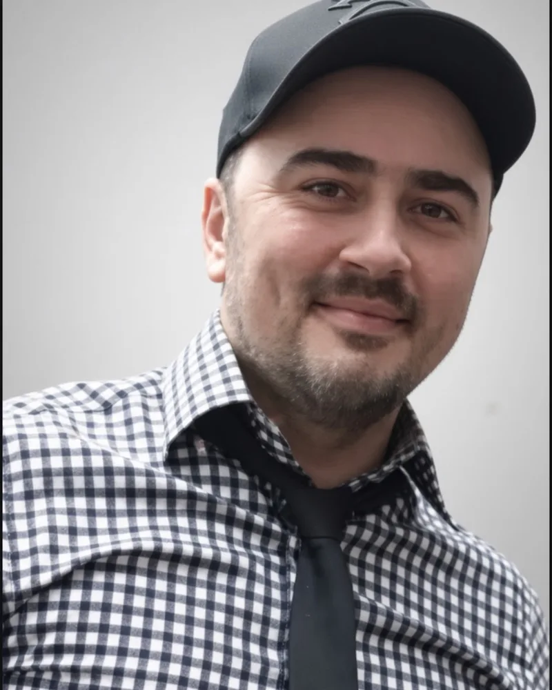 Rudy, owner of Chelsea Gardens Barber Shop